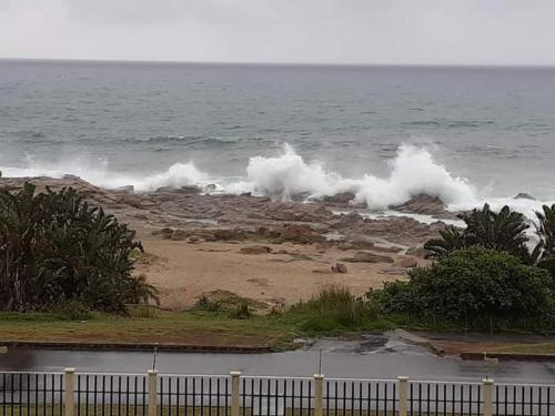 a wave breaking on a beach with the ocean at Astove 6 in Margate