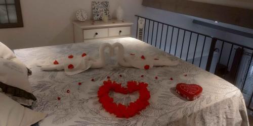 two swans made out of hearts on a bed at Esprit Zen en Provence Studio Spa privatif in Cheval-Blanc