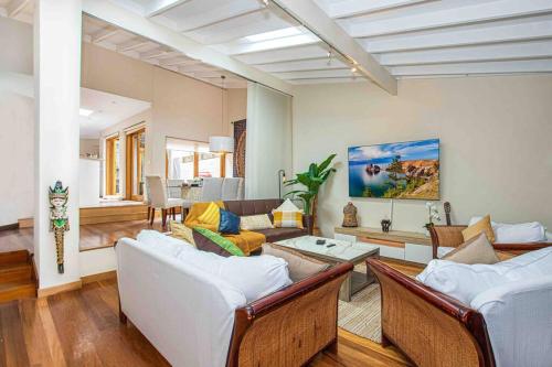 a living room with two couches and a table at Luxury Retreat Home - 4bed House w/Parking - Mins from CBD in Sydney