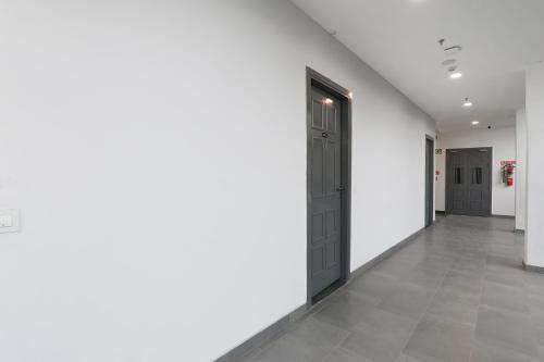 an empty hallway with two doors and a tile floor at FabHotel BSA in Lucknow