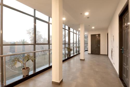 an empty hallway with large windows in a building at FabHotel BSA in Lucknow