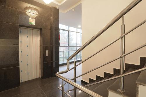 a hallway with stairs and a door in a building at FabHotel BSA in Lucknow