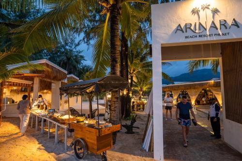 a food stand on the beach with people walking around at Arinara Beach Resort Phuket - SHA Extra Plus in Bang Tao Beach
