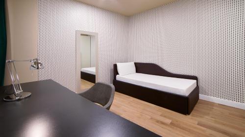 a bedroom with a bed and a desk and a mirror at Holiday Inn Nola - Naples Vulcano Buono by IHG in Nola