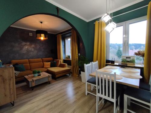 a living room with a table and a couch at Ropienka Ski in Ustrzyki Dolne