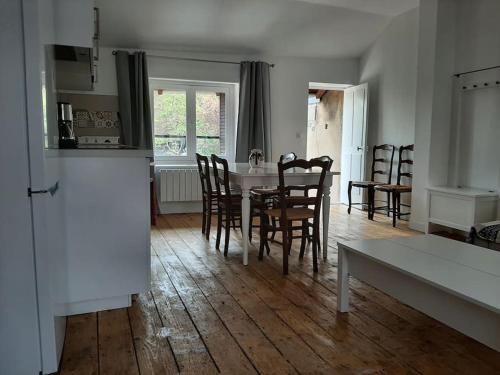 a kitchen and dining room with a table and chairs at Gite le haut des maraichers in Albigny-sur-Saone