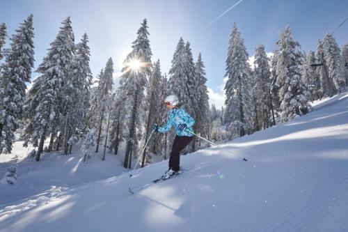 a person is skiing down a snow covered slope at Terme Zreče – Vile Terme Zreče in Zreče
