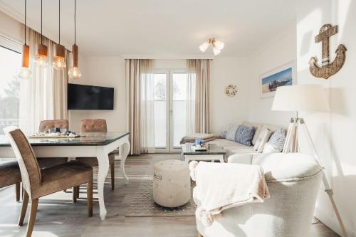 a living room with a couch and a table at Sea Horse in Zingst