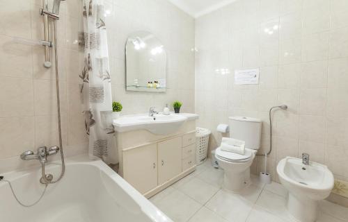 a white bathroom with a sink and a toilet at B36 - Dona Ana Secluded Spot in Lagos