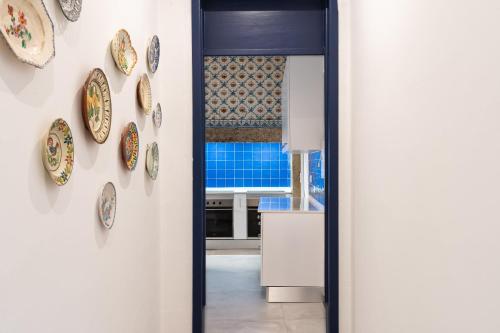 a hallway with plates on the wall at Succeed Terreiro do Paço Suites in Lisbon