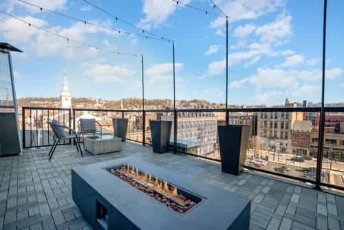 a balcony with a fire pit on top of a building at The Penthouse- Heart of OTR w/Rooftop Terrace in Cincinnati