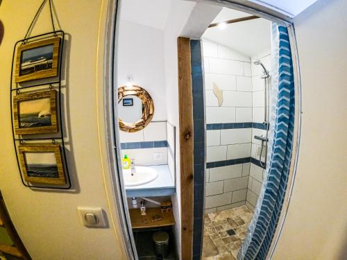 a bathroom with a sink and a mirror at Oleron Surf House in Allards