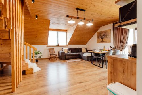 a living room with a couch and a table at Miracle Seasons in Liptovský Mikuláš
