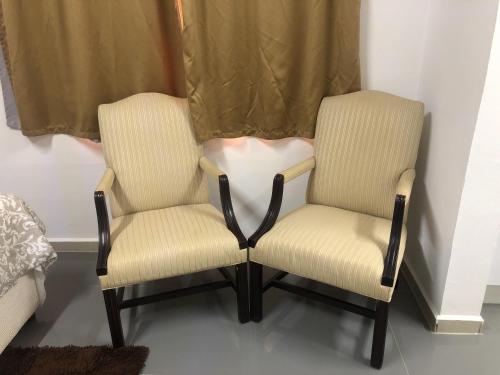 two chairs sitting next to each other in a room at Hotel Bar Restaurant Emergency 911 STO LK GROUP in Paramaribo