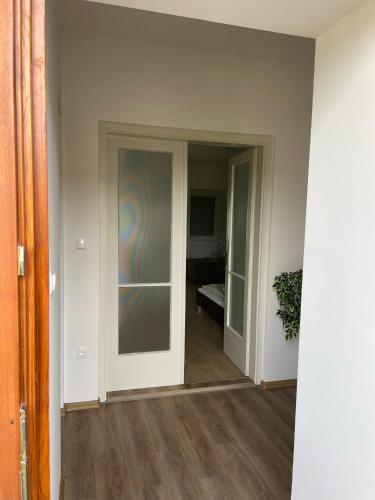 an empty room with a door and a room with a hallway at AA Apartman - Kaposvár in Kaposvár
