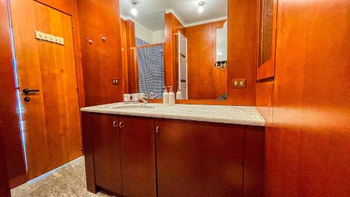 a bathroom with a sink and a mirror at Appartamento La Sequoia - Affitti Brevi Italia in Bardonecchia