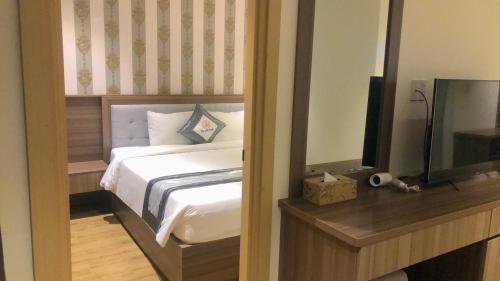 Cama o camas de una habitación en UMI-PQ hotel