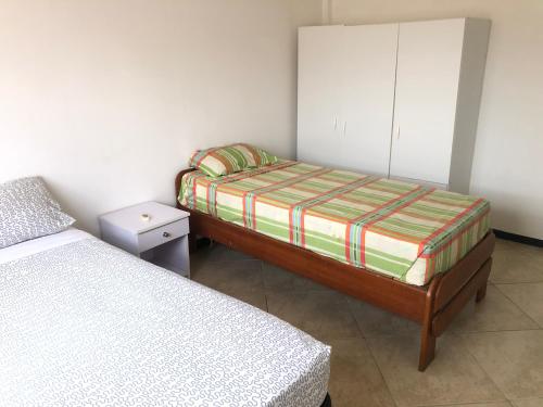a small bedroom with two beds and a cabinet at Hotel Bar Restaurant Emergency 911 STO LK GROUP in Paramaribo