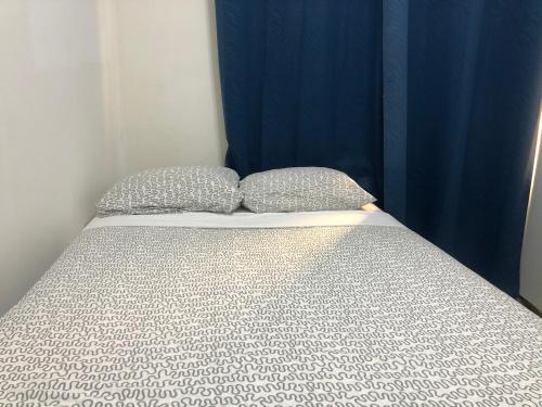 a bed with two pillows on top of it at Hotel Bar Restaurant Emergency 911 STO LK GROUP in Paramaribo