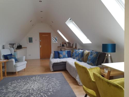 a living room with a couch and chairs at Fieldside Barn in Long Wittenham