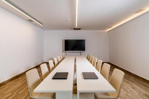 a conference room with a long table and chairs at Cresanto Luxury Suites in Imerovigli