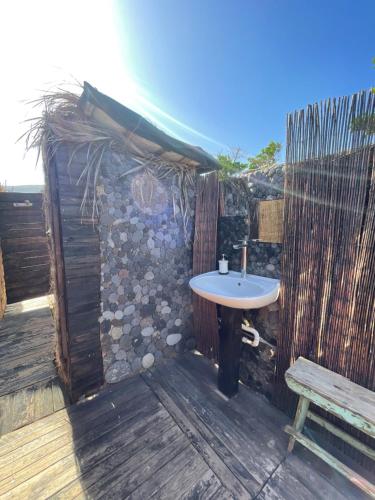 a bathroom with a sink on a deck with a bench at Los Pajaros in Santa Cruz de Tenerife