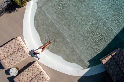 an overhead view of a person in a swimming pool at Cresanto Luxury Suites in Imerovigli