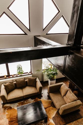a living room with a couch and some windows at CONTELE VLADIMIR in Bran
