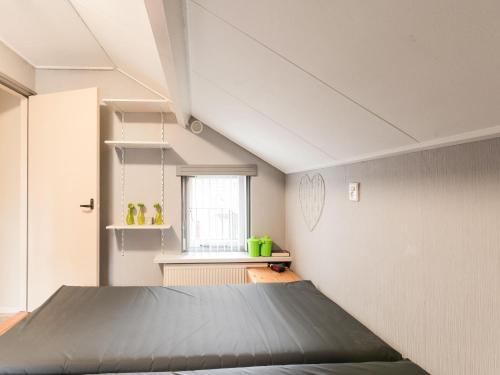 a bedroom with a bed and a window at Comfortable upstairs apartment with a terrace in Eefde in Eefde