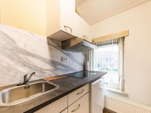 a kitchen with a sink and a window at Comfortable upstairs apartment with a terrace in Eefde in Eefde