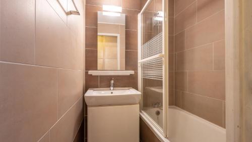 a bathroom with a sink and a toilet and a shower at Grand Morillon-309 Appart vue pistes- 5 pers in Morillon