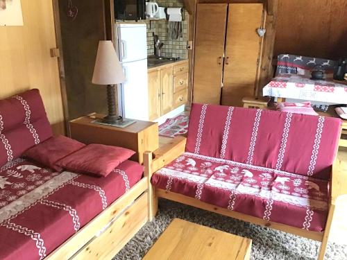 a living room with two beds and a table at Chalet de 2 chambres avec jardin amenage et wifi a Autrans Meaudre en Vercors in Autrans