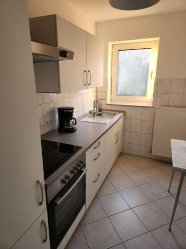 a small kitchen with a stove and a window at Wohnung in Dortmund in Dortmund