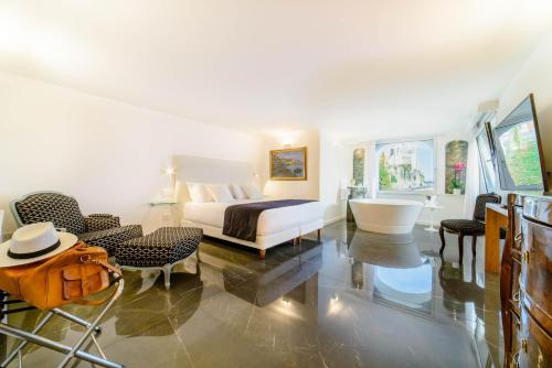 a bedroom with a bed and a bathroom with a tub at Palazzo Don Salvatore in Amalfi