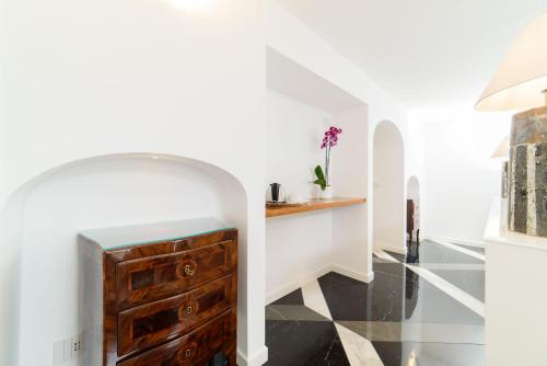 a bathroom with a wooden chest of drawers and a sink at Palazzo Don Salvatore in Amalfi