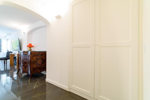 a hallway with white cabinets and a table at Palazzo Don Salvatore in Amalfi