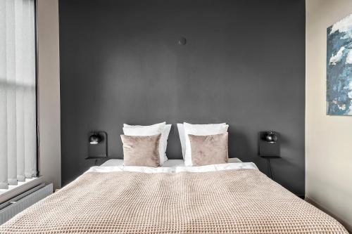 a bedroom with a large bed with two pillows at Best Western Royal Holstebro in Holstebro
