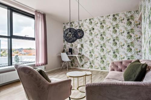 a living room with a couch and a table at Best Western Royal Holstebro in Holstebro