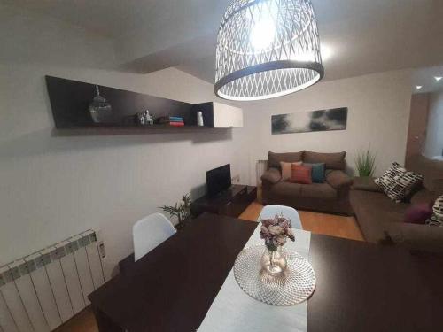 a living room with a table and a couch at Apartamento San Andrés in Teruel