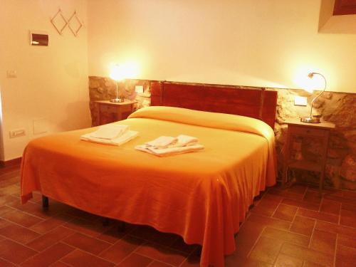 a bedroom with a bed with two towels on it at Agriturismo Ristorante Monte Argentario in Monte Argentario