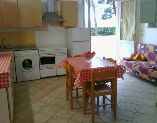 a kitchen with a table and a kitchen with a couch at Agriturismo Ristorante Monte Argentario in Monte Argentario