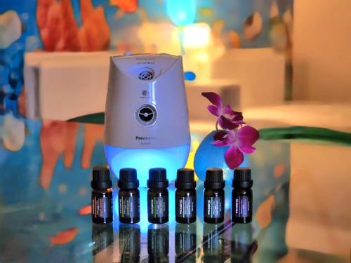 a group of five bottles of essential oils on a table at Villa Blu Okinawa Chatan 3-3 ヴィラブルー沖縄北谷3-3 "沖縄アリーナ徒歩圏内の民泊ホテル" in Chatan