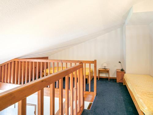 a attic room with a bed and a staircase at Appartement Val-d'Isère, 2 pièces, 4 personnes - FR-1-694-249 in Val-d'Isère
