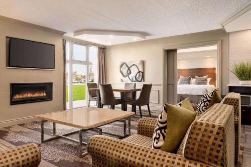 a living room with a couch and a fireplace at Ramada by Wyndham Cornwall in Cornwall