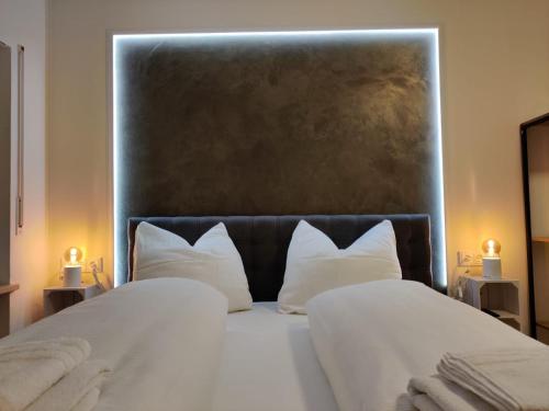 a bedroom with a large bed with white pillows at Schicke Wohnungen in Stadtnähe in Würzburg