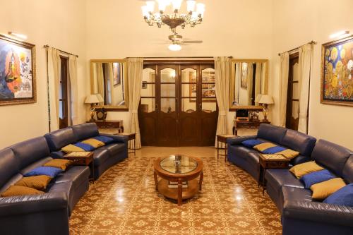 a living room with couches and a coffee table at Surya Kiran Heritage Hotel in Panaji