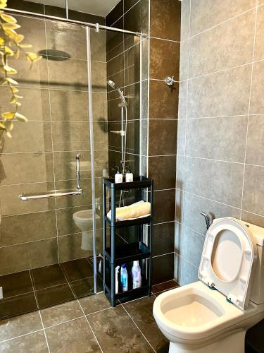 a bathroom with a shower and a toilet and a sink at Ipoh Peaceful Onsen studio Lost World Tambun in Tambun