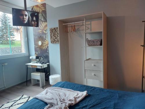 a bedroom with a bed and a desk and a window at Style of Industry in Morbier
