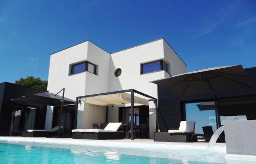 ein Haus mit einem Pool neben einer Villa in der Unterkunft Luxueuse propriété SAINT CIRICE aux vues aériennes in Cahors