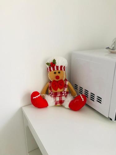 a teddy bear sitting on a counter next to a microwave at B&B Via dell'Azzurra in Bari